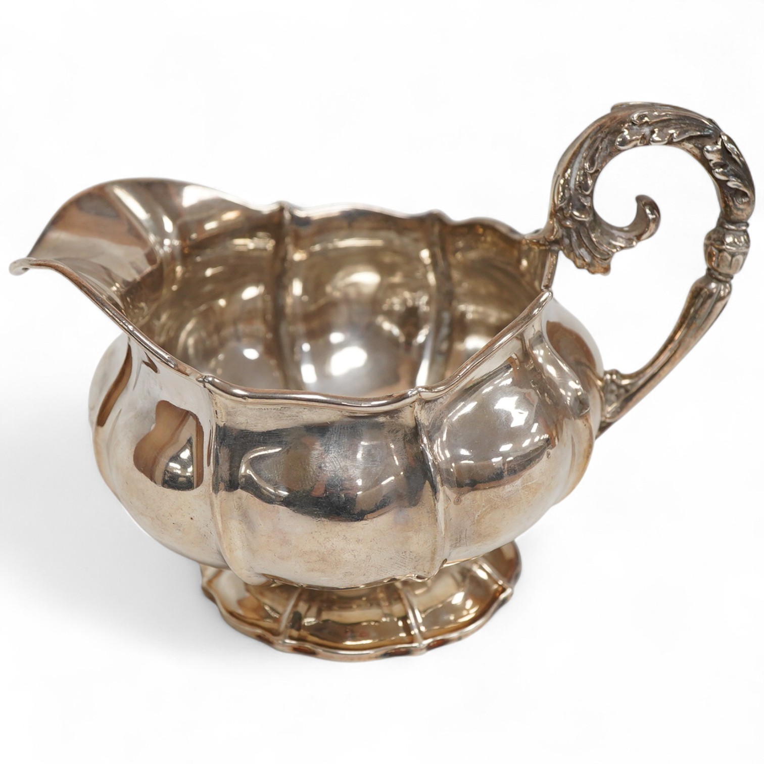 A George IV silver cream jug, with engraved monogram, by William, Charles and Henry Eley, London, 1824, height 10.5cm, 7.7oz.